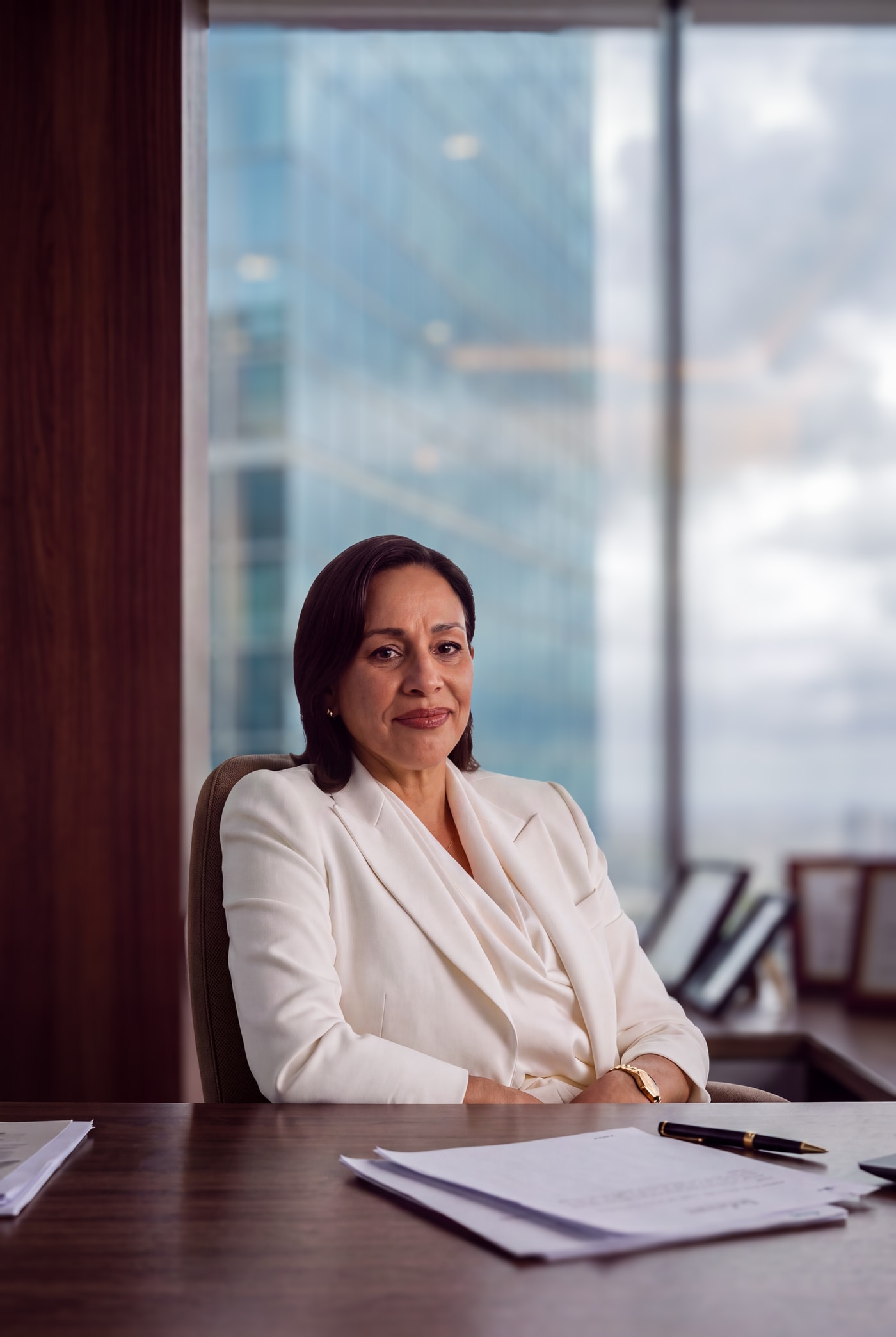 An attorney seated at her desk in a high-rise office.
